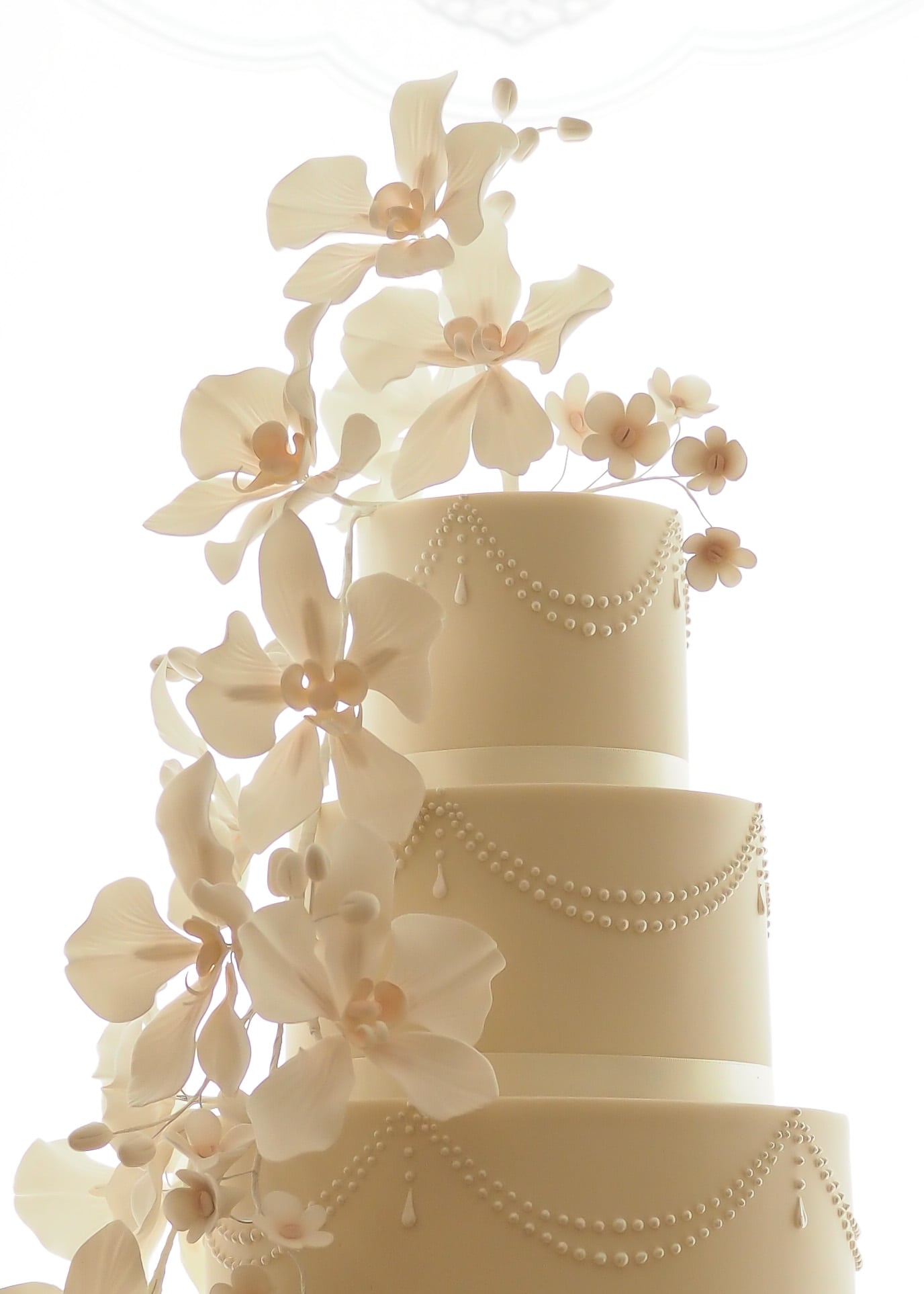 Orchids, Pearls and Drapes Wedding Cake with sugar flowers