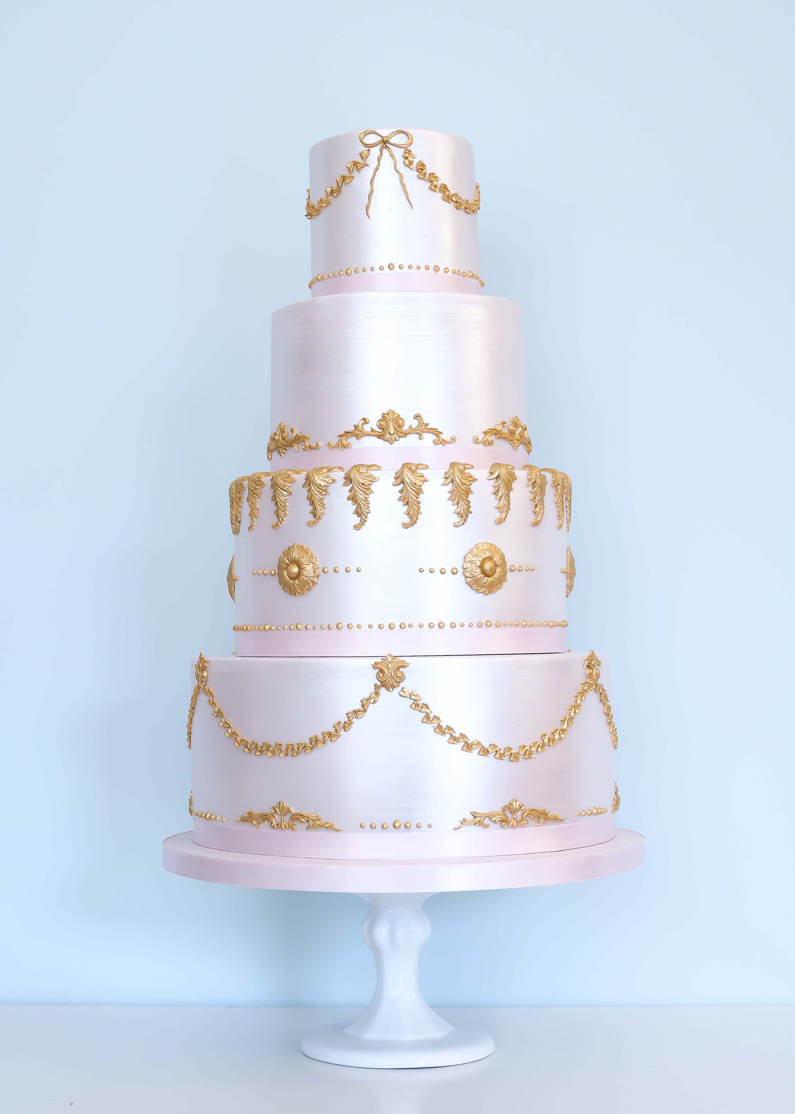 Pink and gold baroque shimmer wedding cake